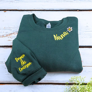 Folded Forest Green Nana Sweatshirt with flower icon and Grandkids' Names on Sleeve, A Meaningful and cozy Gift for Nana