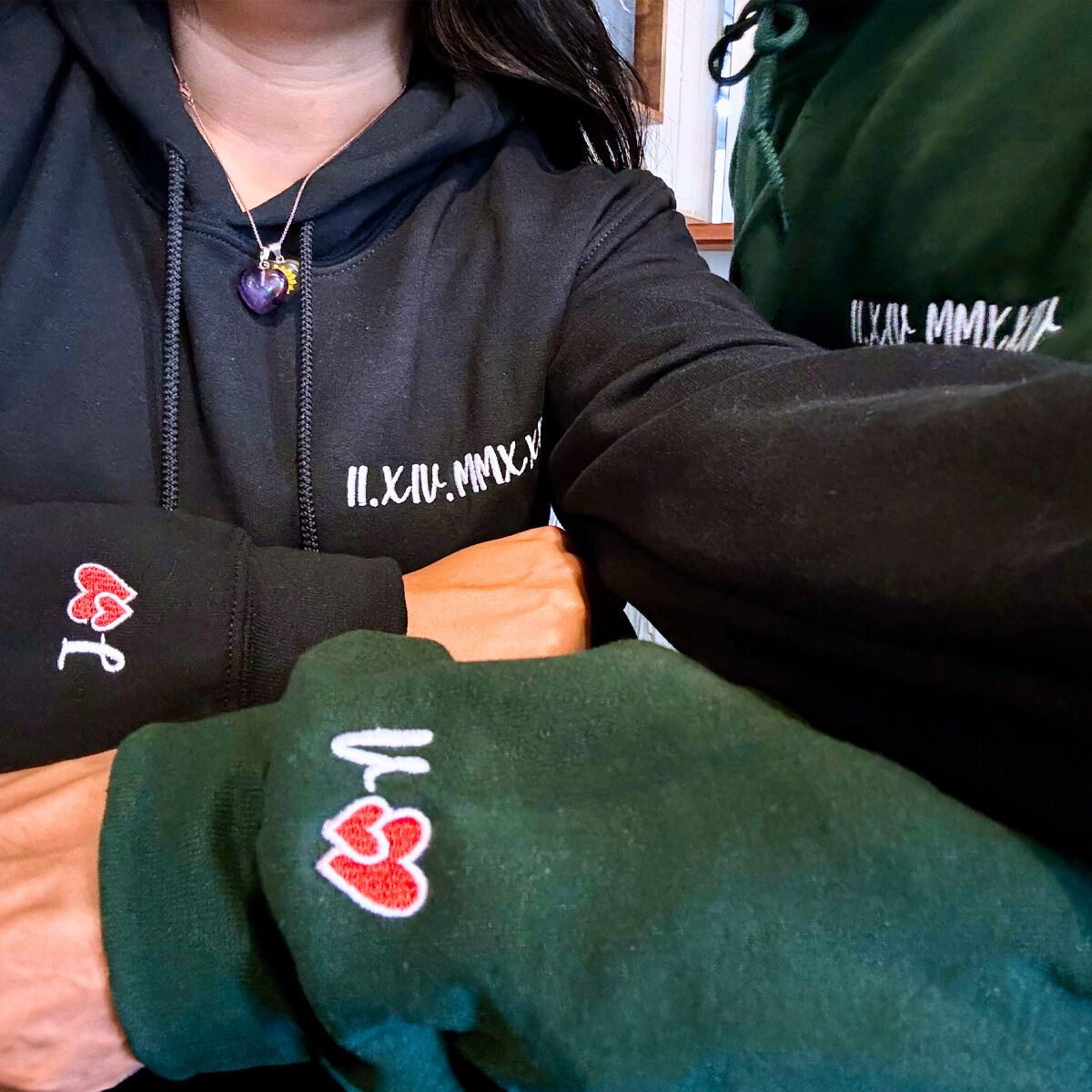 Happy couple wearing roman sweatshirt with initials on sleeve