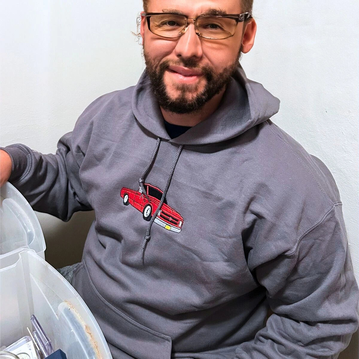 A man wearing a custom truck sweatshirt, a meaningful and cozy gift for trucker lover