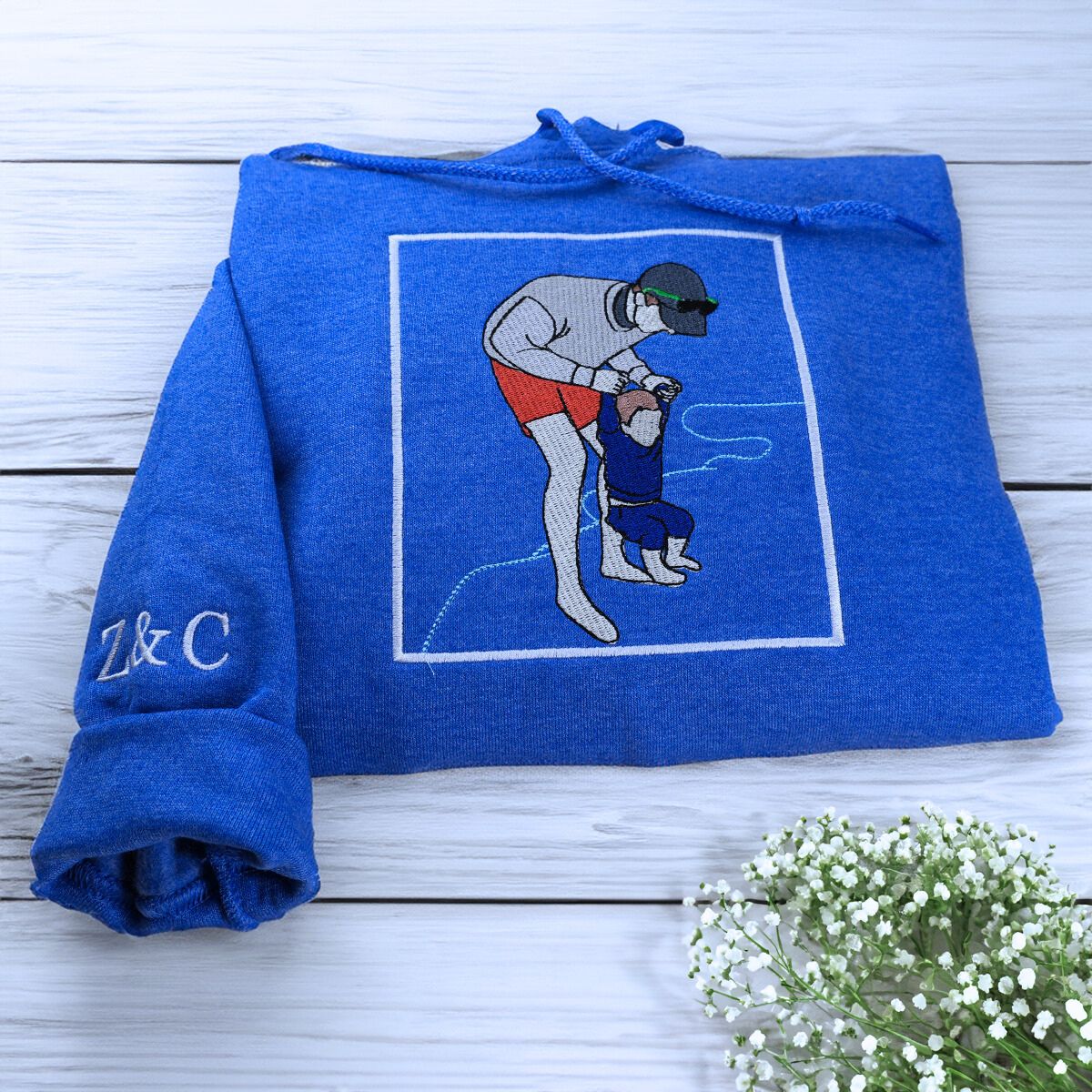 Folded Royal Blue Dad Hoodie with Kid's Name on leeve, a meaningful gift for Dad