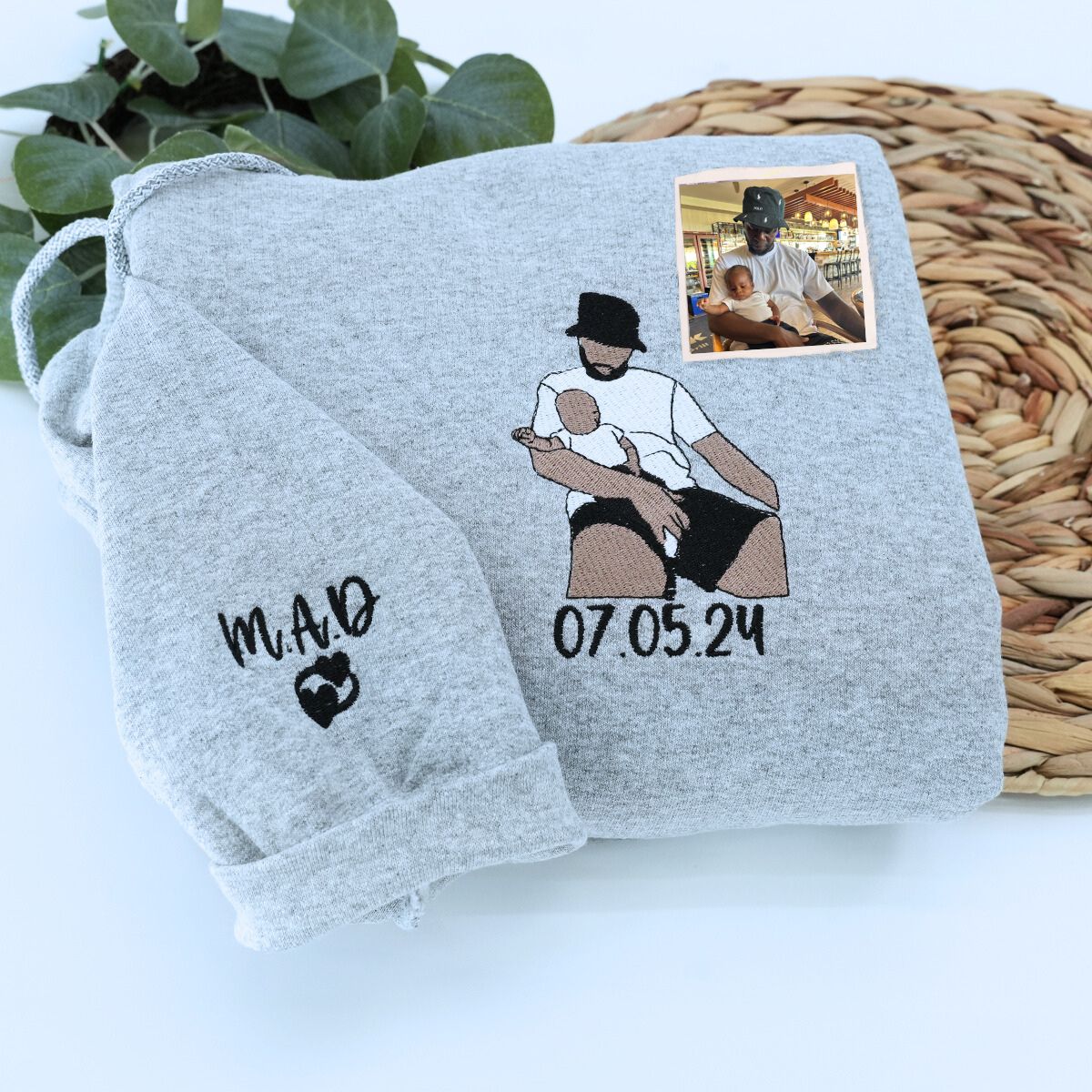 Folded Sport Gray Dad Hoodie with Kid's Name and Heart icon on Sleeve, a meaningful and cozy gift for dad