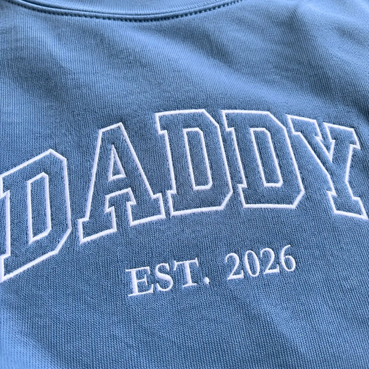 Custom embroidered Daddy Est t-shirt with high-density stitching, personalized gift for a new dad.