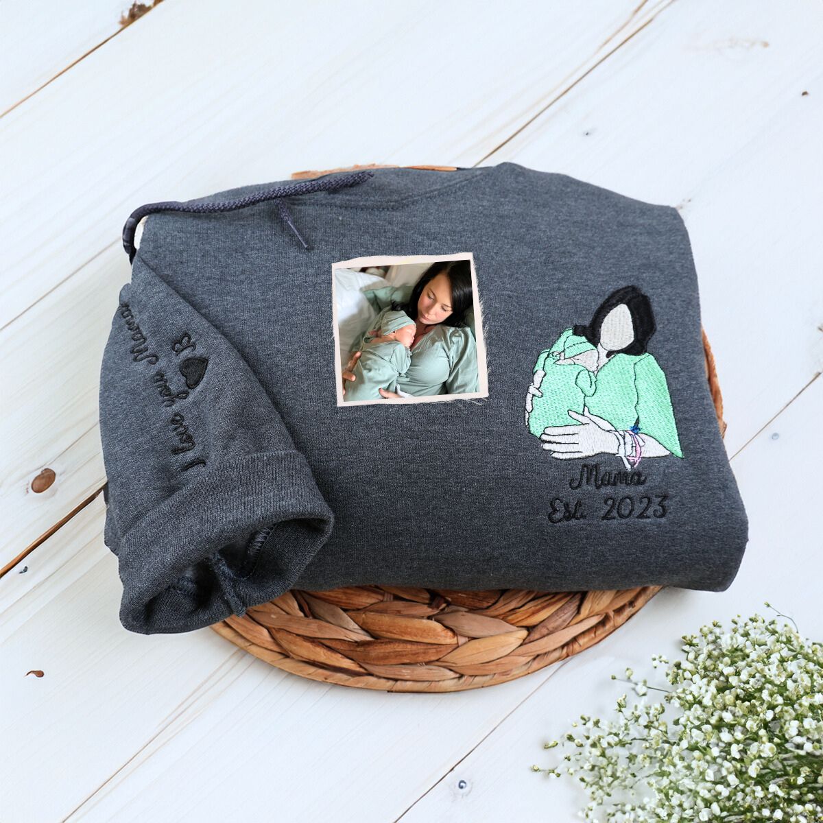 Folded Dark Heather Mom Hoodie with New Mom and Newborn Baby Embroidery, a meaningful and cozy gift for newt mom 