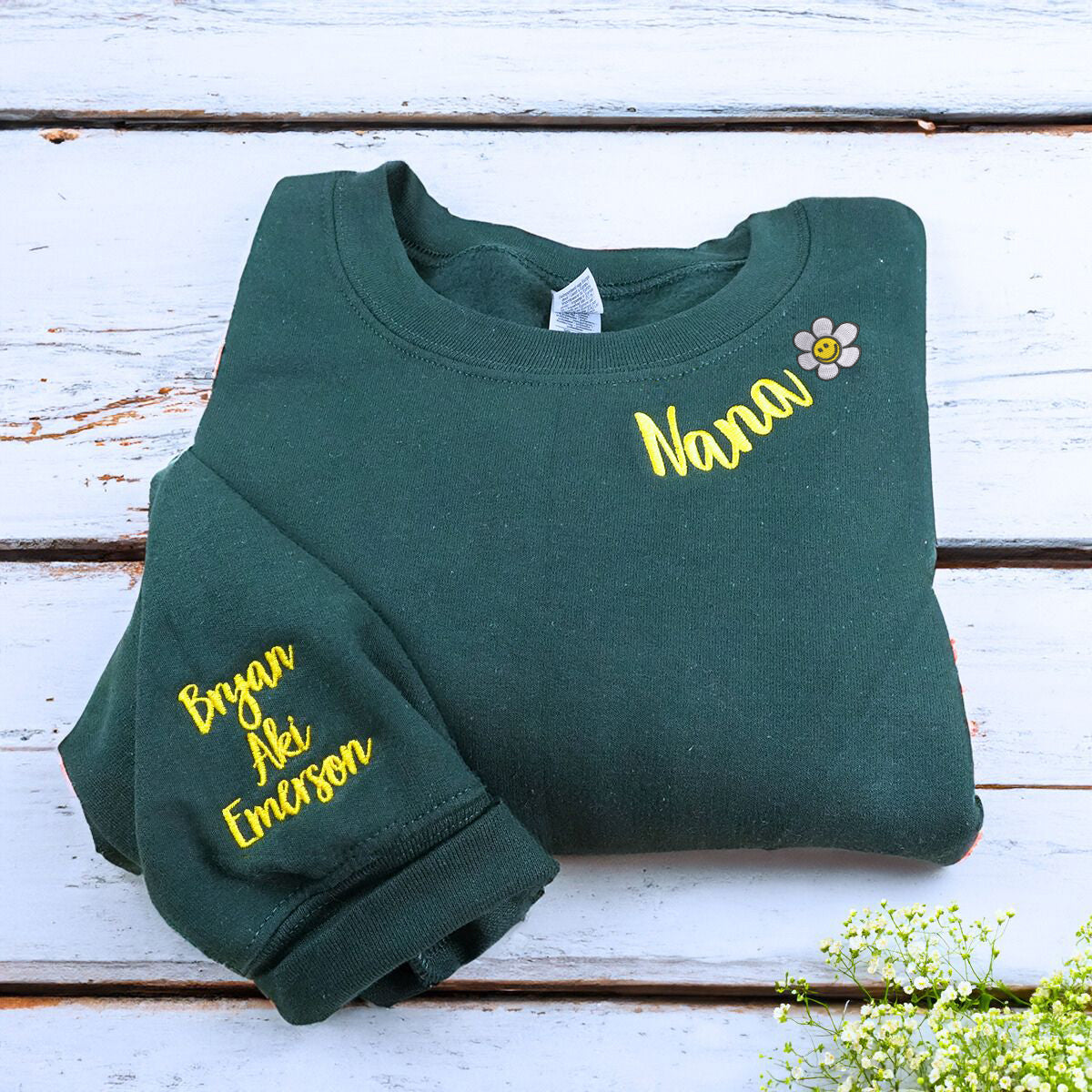 Folded Forest Green Nana Sweatshirt with flower icon and Grandkids' Names on Sleeve, A Meaningful and cozy Gift for Nana