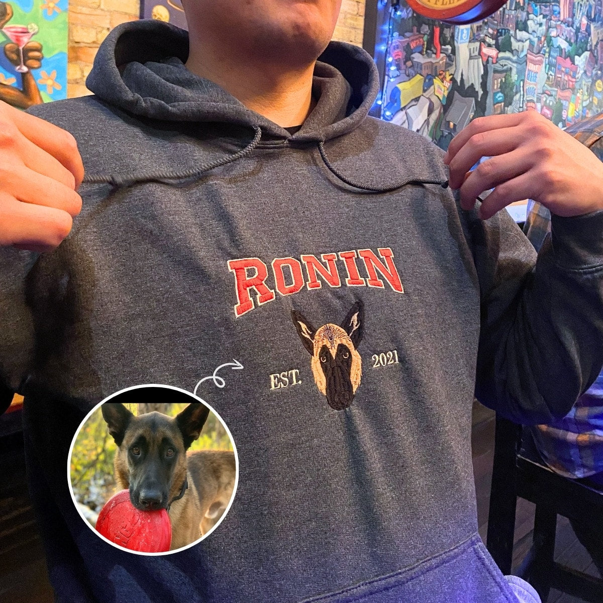 Embroidered hoodie showing dog portrait with name “Ronin” as a custom pet gift