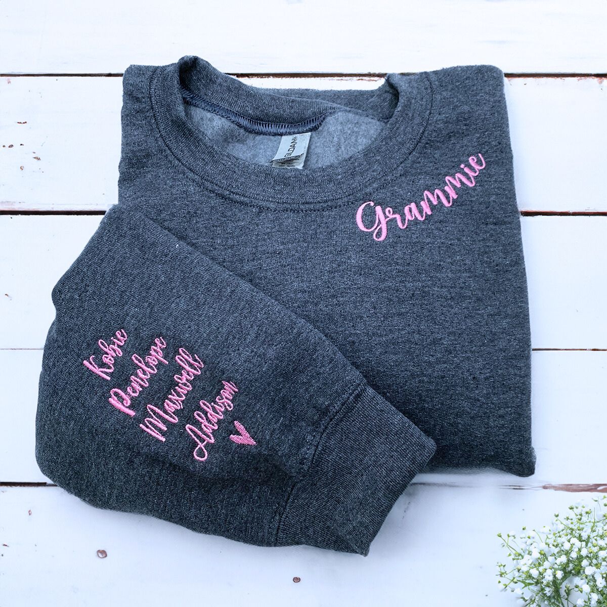 Dark Heather Grammie Sweatshirt with Grandkids' names and heart icon on sleeve, a meaningful and cozy gift for Grammie