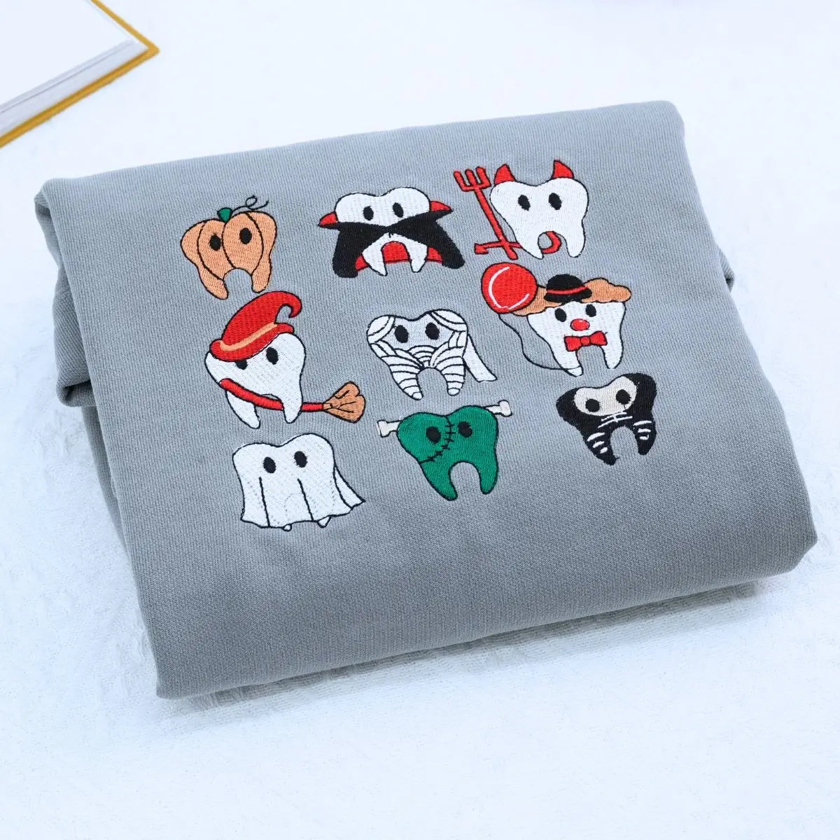 Embroidered spooky Halloween dentist shirt with teeth design, ideal for dental professionals