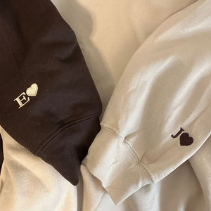 Initial heart embroidered on sleeve