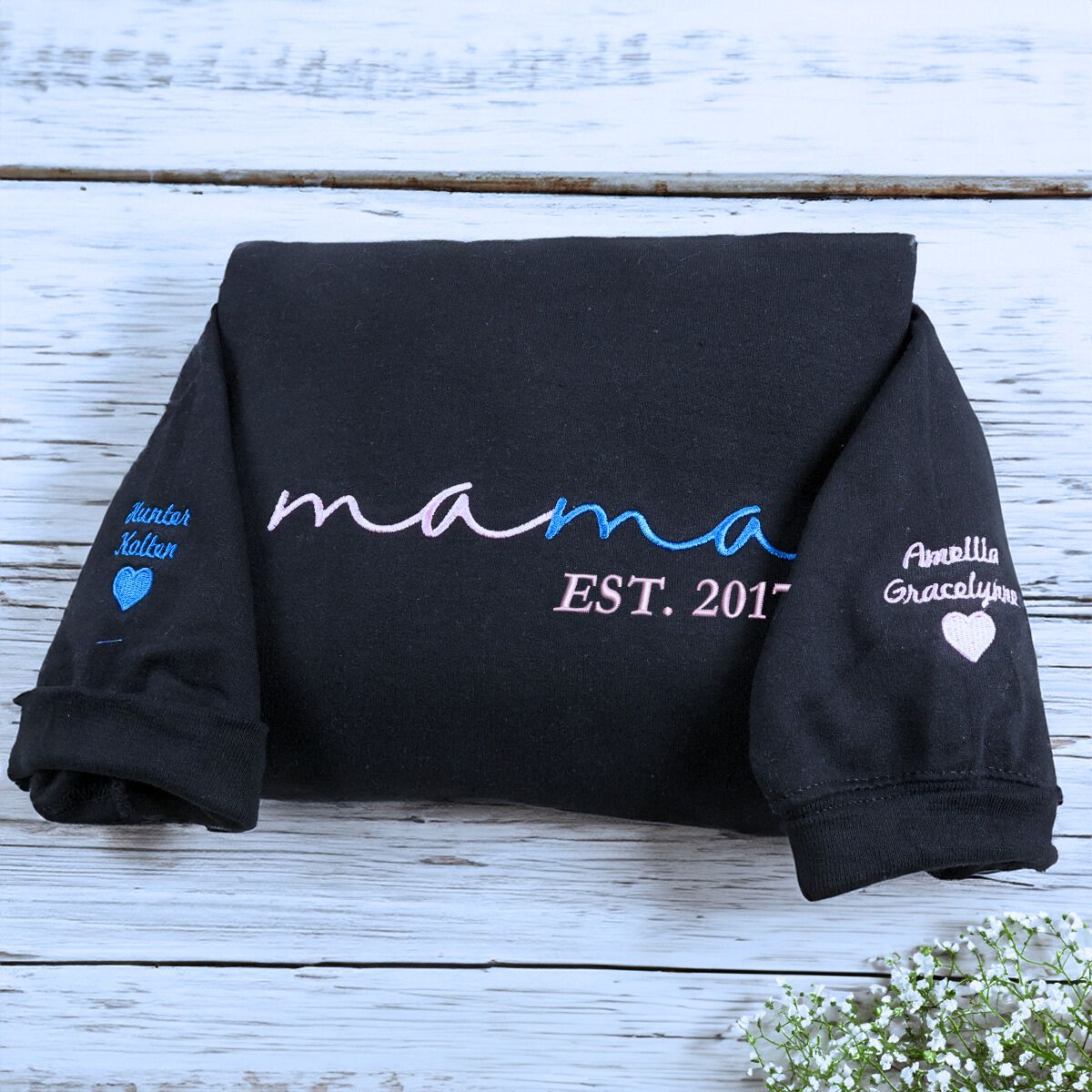 Folded Black Mama Sweatshirt with 'EST. 2017' embroidery and Kids' names on Sleeve, a meaningful gift for mama