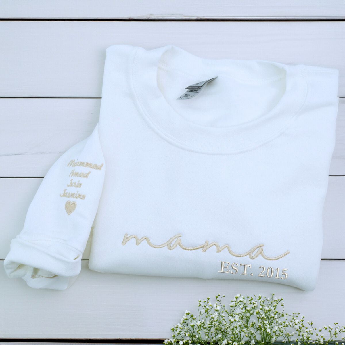 Folded White Mama Sweatshirt with 'EST. 2015 embroidery and Kids' names on Sleeve, a meaningful gift for mama