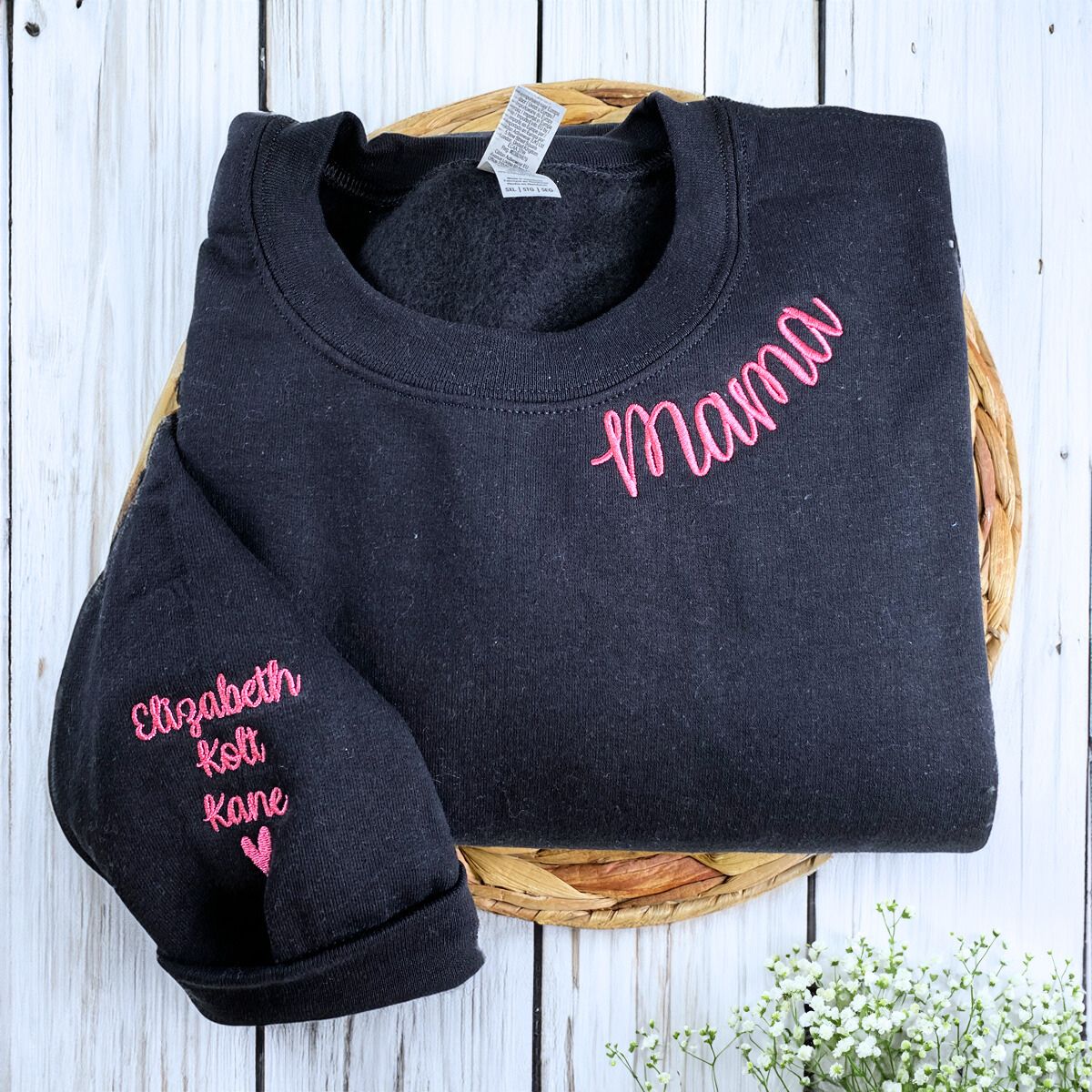 Folded Black Mama Sweatshirt with Kids' Names and Heart icon on the Sleeve