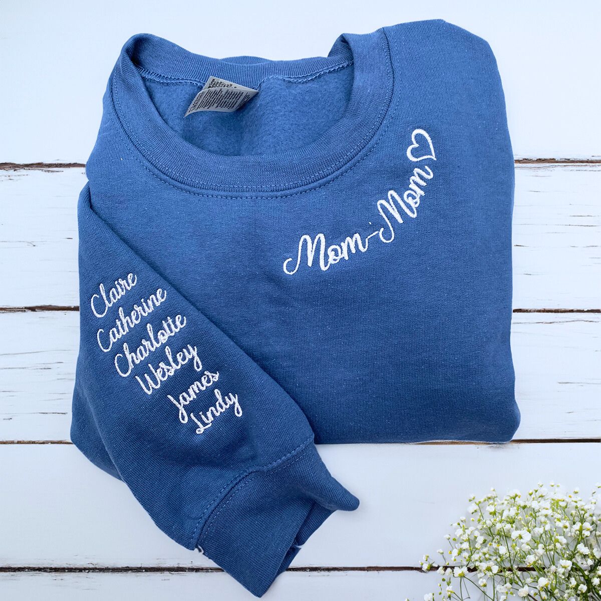 Folded Indigo Blue Mom-mom Sweatshirt with Kids' Names on the Sleeve