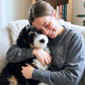 Close-up of personalized embroidery featuring a dog's face and name on a high-quality sweatshirt.
