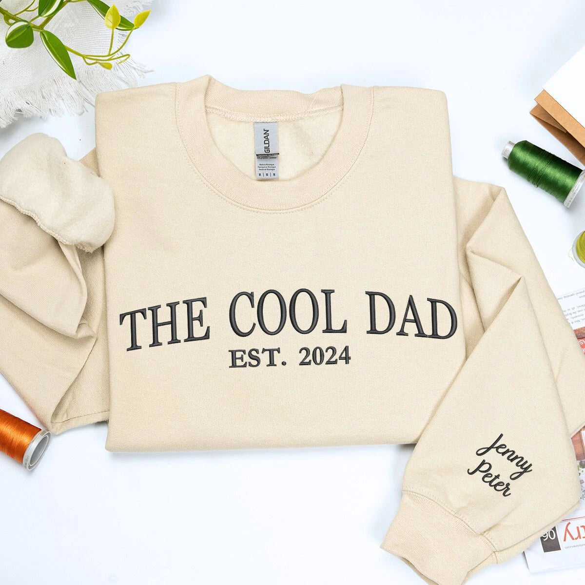 Sand The Cool Dad Sweatshirt with EST. 2024 embroidery and kid name on sleeve, a meaningful and cozy gift for dad