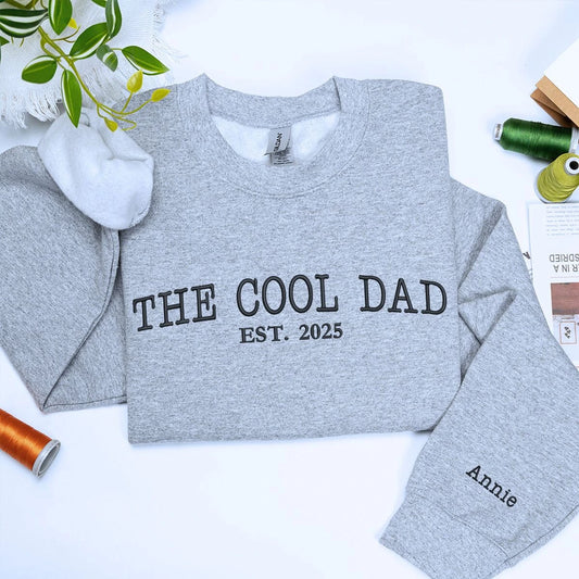 Sport Gray The Cool Dad Sweatshirt with EST. 2025 embroidery and kid name on sleeve, a meaningful and cozy gift for dad