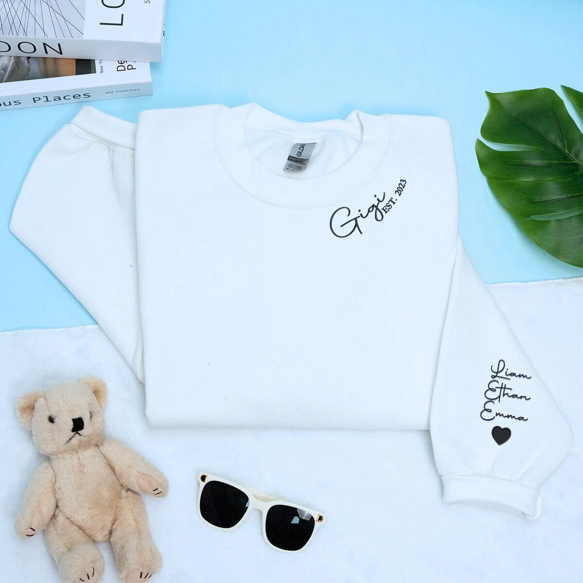 White Gigi Sweatshirt with 'Est. 2023' embroidery with grandkids names on sleeve, a meaningful and cozy gift for Gigi