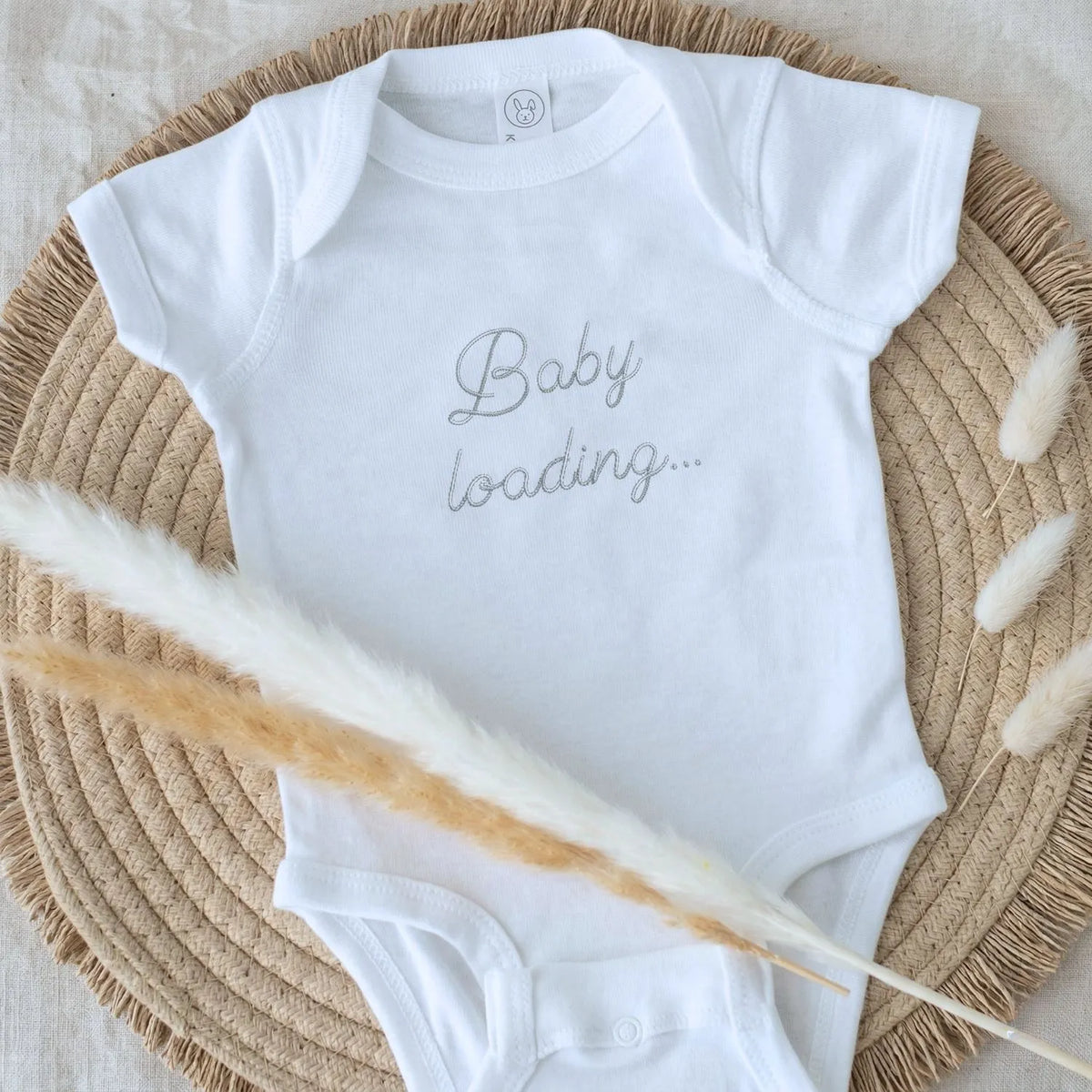 Embroidered baby announcement onesie with “Baby Loading” text for pregnancy reveal