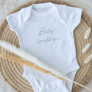 Embroidered baby announcement onesie with “Baby Loading” text for pregnancy reveal