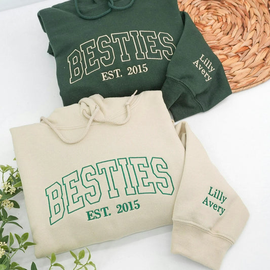 A custom embroidered Sand and Forest Green Besties sweatshirt made for the friend who knows every chapter, with names and an established year stitched into the design