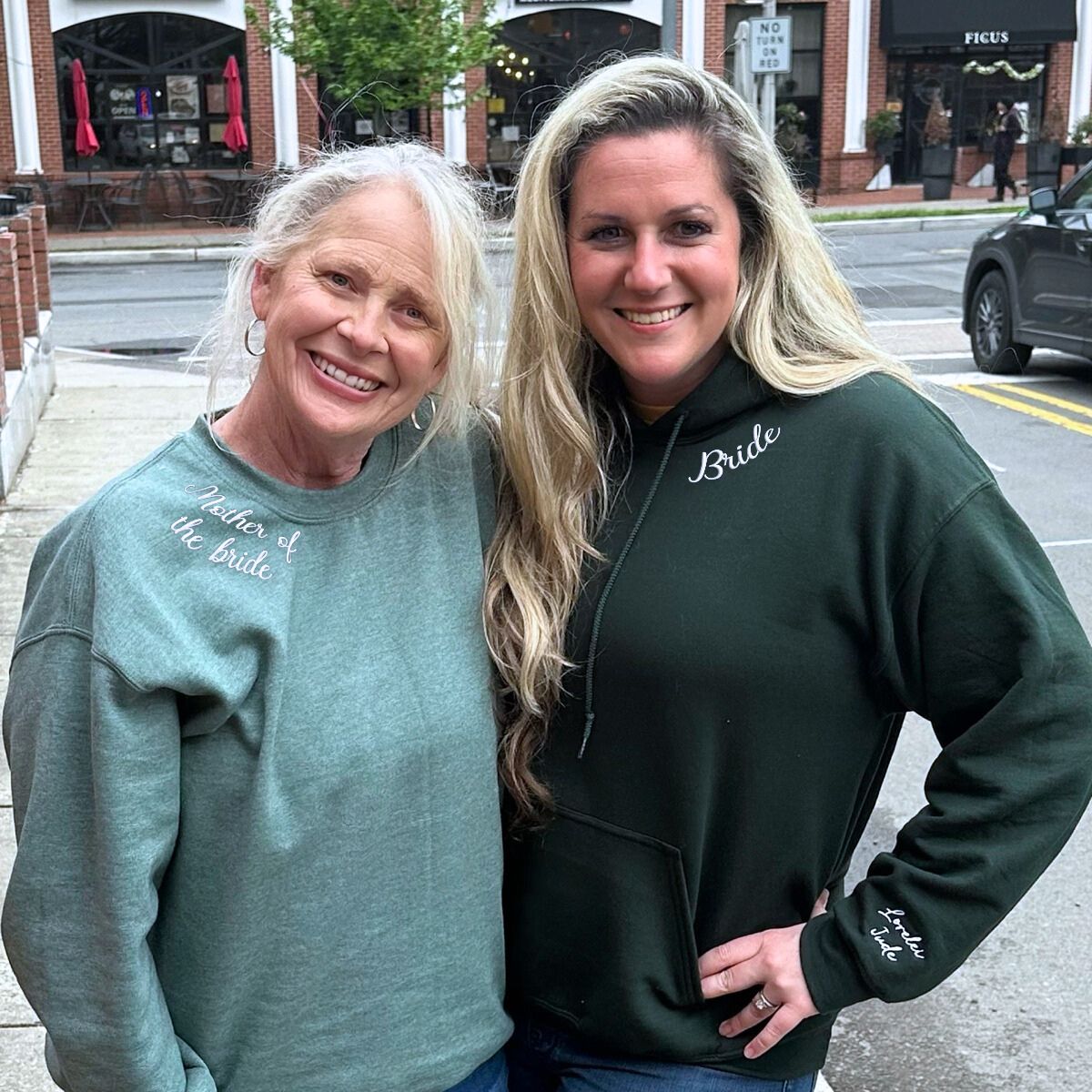 Bride and her mother in embroidered sweatshirts, enjoying a casual day out.