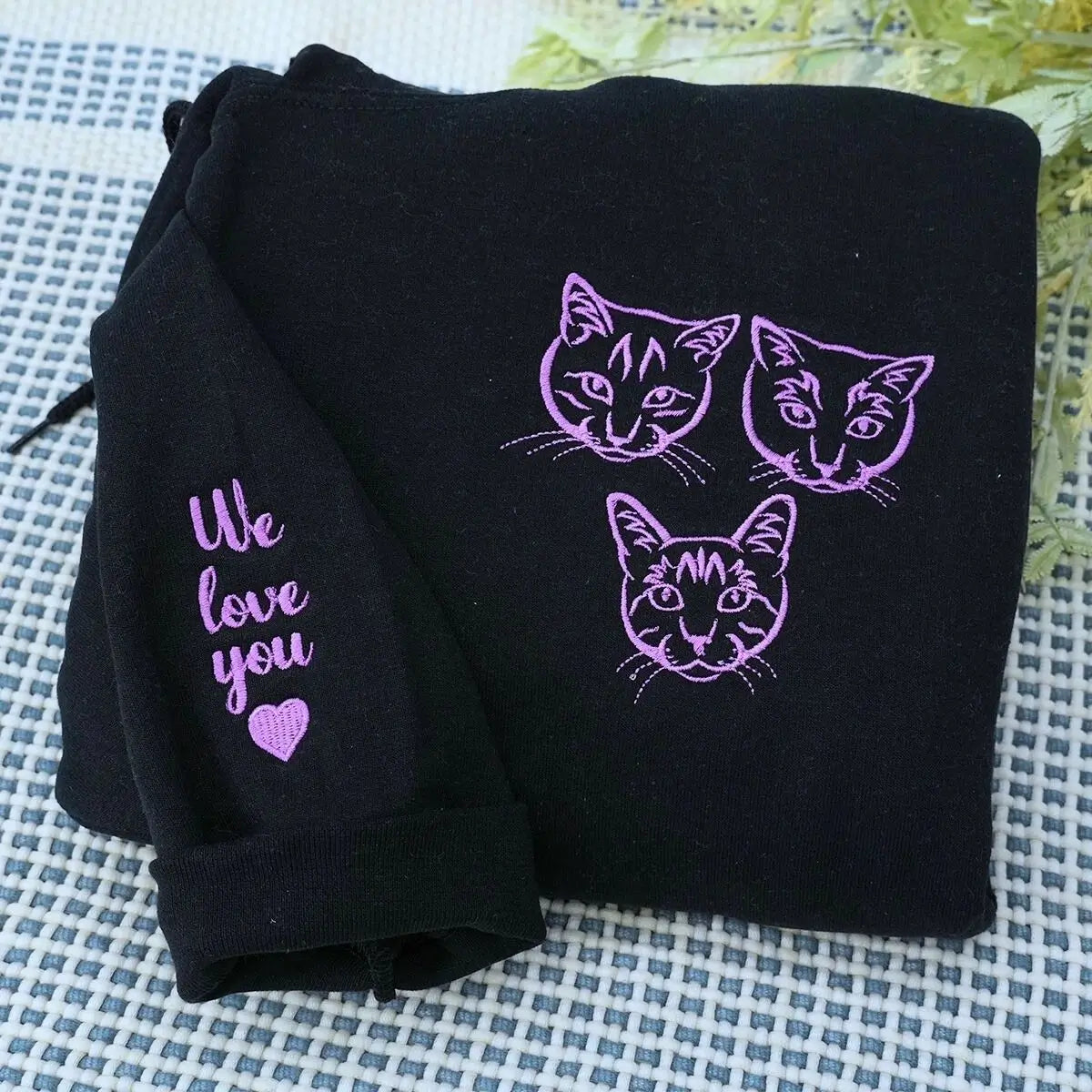Cat-themed crewneck sweatshirt and hoodie set folded with paw print and cat design details visible