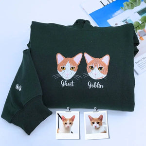 Cat-themed crewneck sweatshirt and hoodie set folded with paw print and cat design details visible