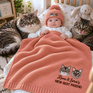 Baby beside two tabby cats under a coral knit blanket embroidered with their portraits, a personalized baby shower gift for cat-loving families.