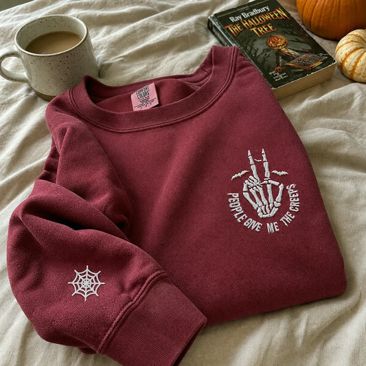 Embroidered Comfort Color® Halloween Sweatshirt - People Give Me The Creeps Skeleton Hand Pullover