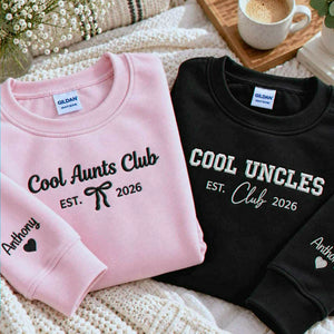 Folded pink Cool Aunts Club and black Cool Uncles Club embroidered sweatshirts with personalized sleeve names, a Christmas gift for aunts and uncles.