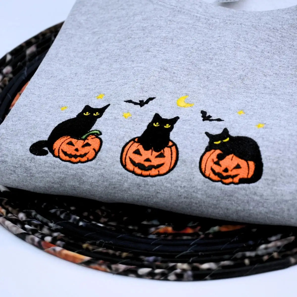 Custom embroidered black cat Halloween sweatshirt with pumpkin, bats, moon and personalized sleeve text