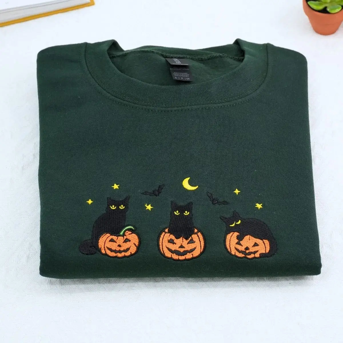 Custom embroidered black cat Halloween sweatshirt with pumpkin, bats, moon and personalized sleeve text