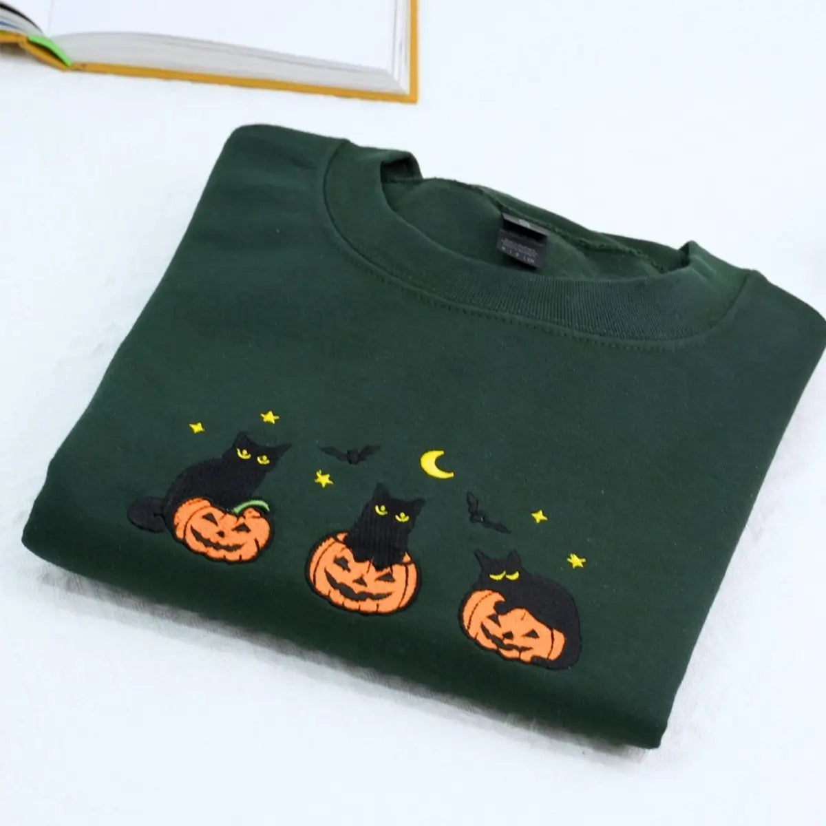 Custom embroidered black cat Halloween sweatshirt with pumpkin, bats, moon and personalized sleeve text