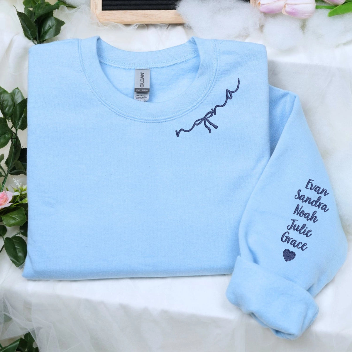 Custom embroidered mama sweatshirt with coquette bow and kids names stitched on sleeve in soft neutral fabric