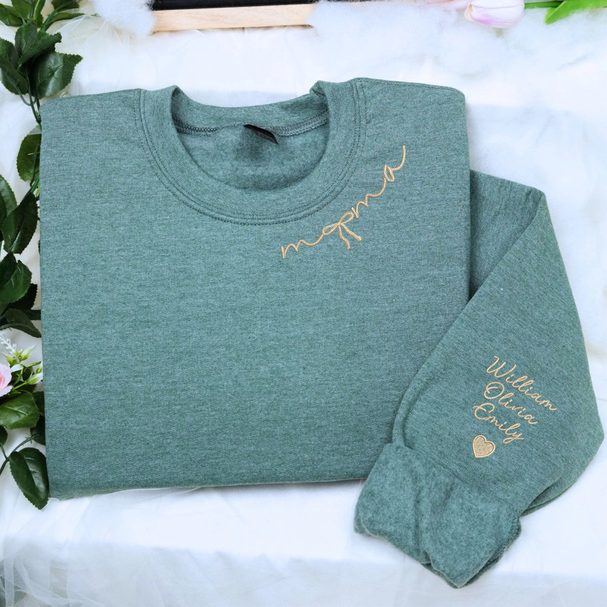 Custom embroidered mama sweatshirt with coquette bow and kids names stitched on sleeve in soft neutral fabric