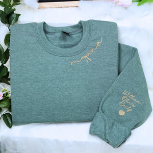 Custom embroidered mama sweatshirt with coquette bow and kids names stitched on sleeve in soft neutral fabric