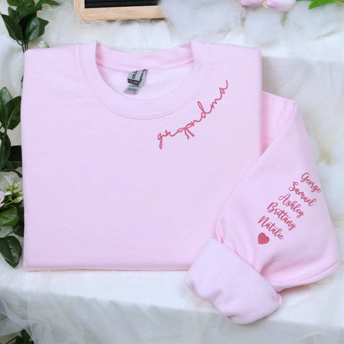 Custom embroidered mama sweatshirt with coquette bow and kids names stitched on sleeve in soft neutral fabric