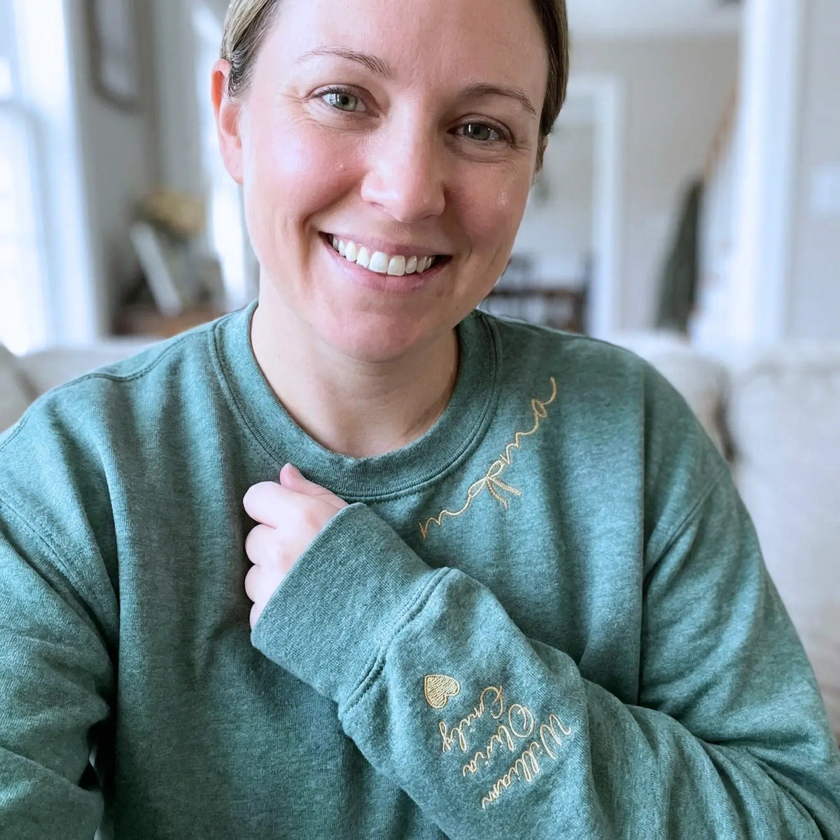 Custom embroidered mama sweatshirt with coquette bow and kids names stitched on sleeve in soft neutral fabric