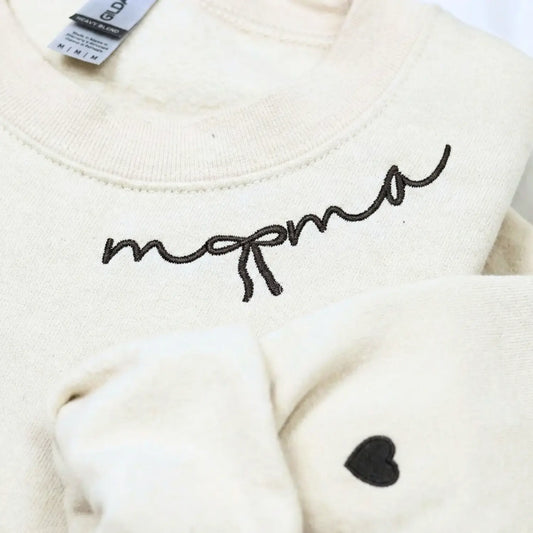 Custom embroidered mama sweatshirt with coquette bow and kids names stitched on sleeve in soft neutral fabric
