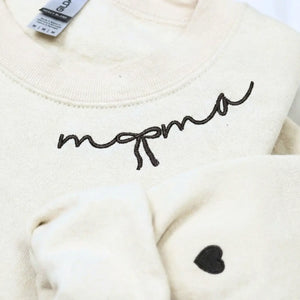 Custom embroidered mama sweatshirt with coquette bow and kids names stitched on sleeve in soft neutral fabric