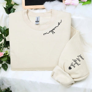 Custom embroidered mama sweatshirt with coquette bow and kids names stitched on sleeve in soft neutral fabric