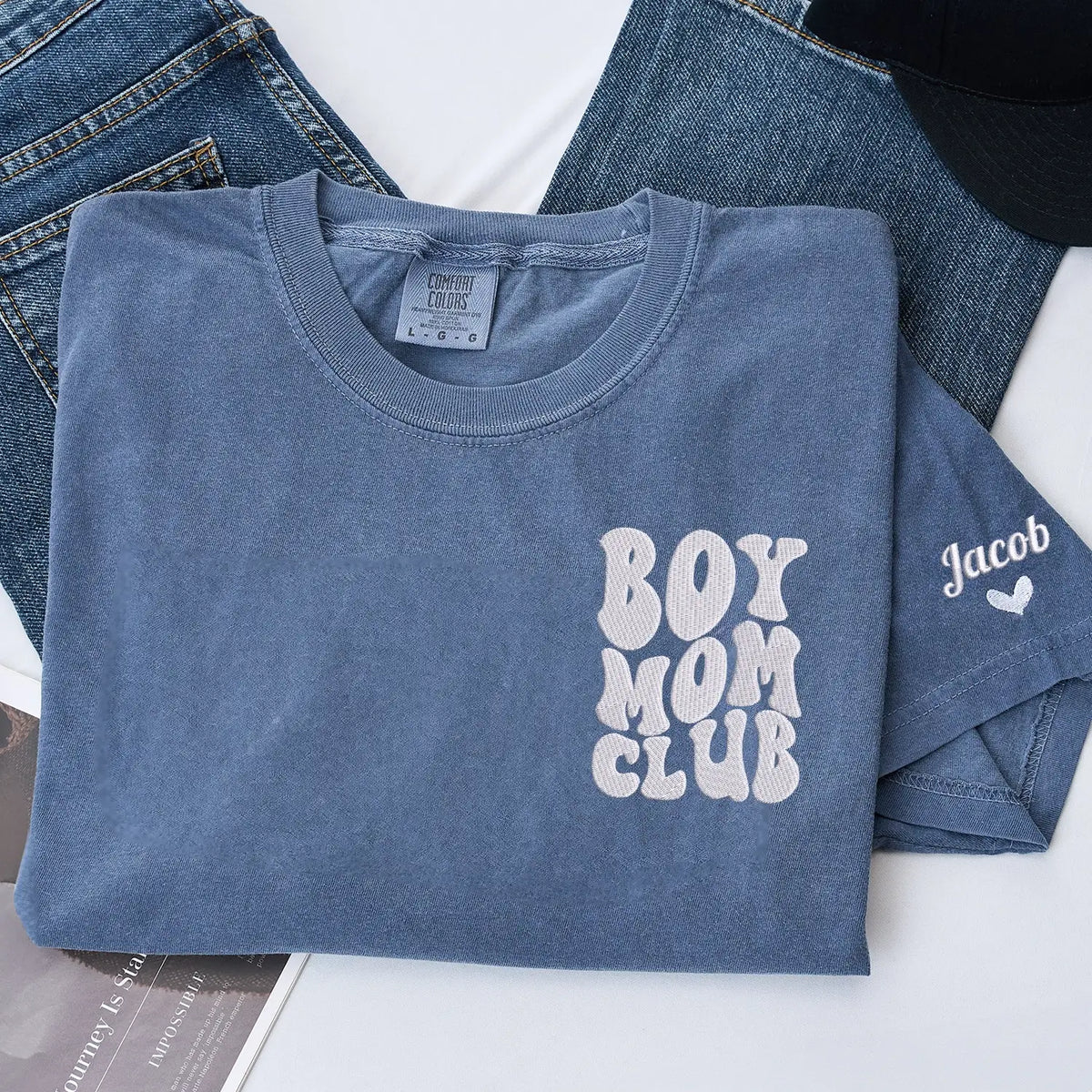 Custom embroidered boy mom shirt with kids names on sleeve personalized gift for new mother wearing casual outfit