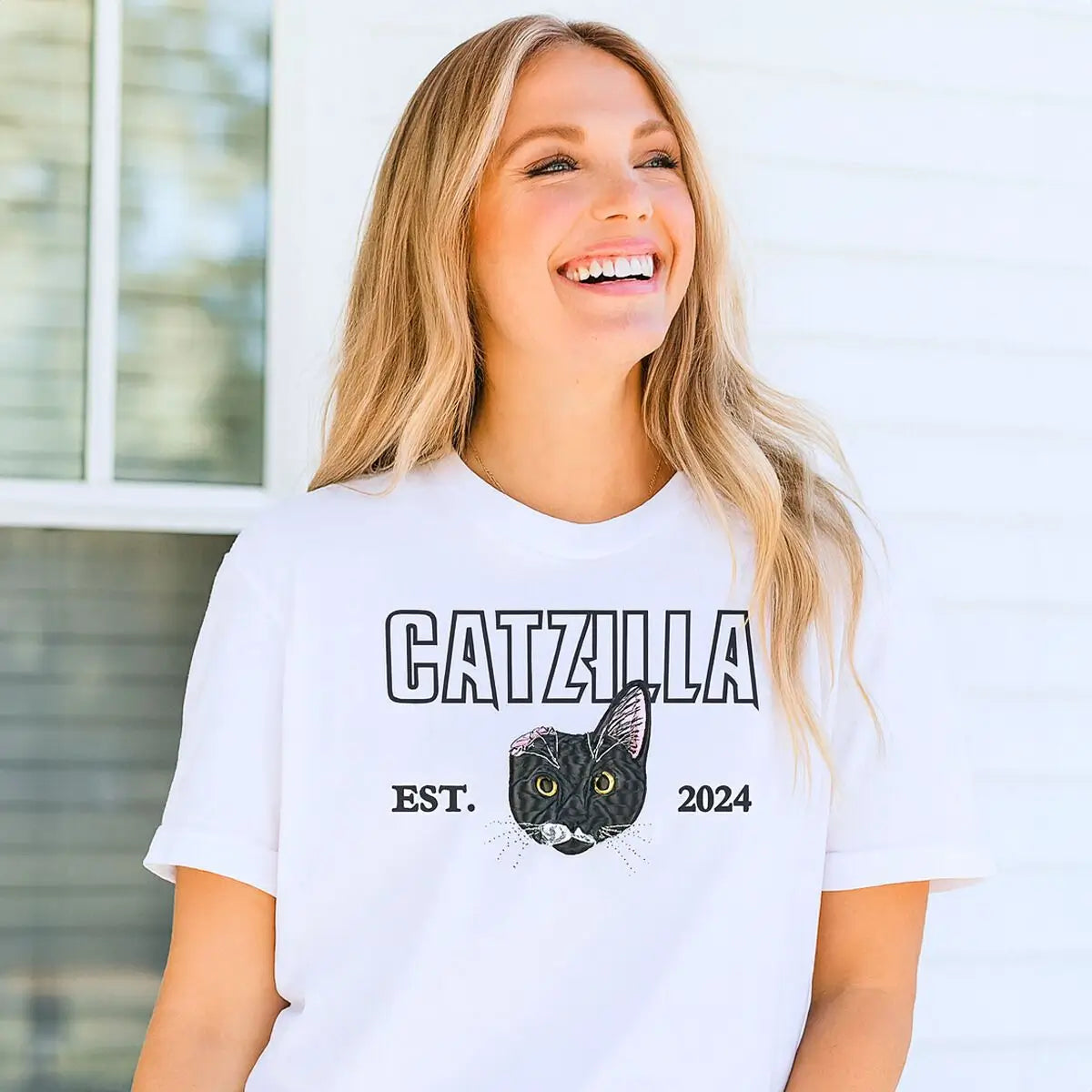 Alt Text suggestion: custom embroidered cat face t shirt with personalized sleeve text