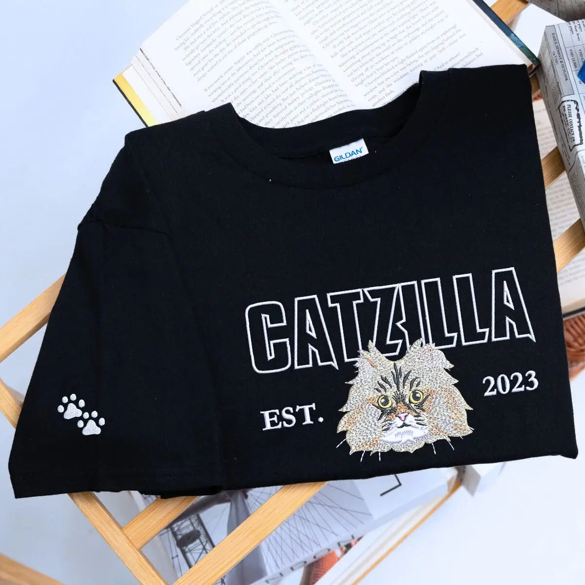 Alt Text suggestion: custom embroidered cat face t shirt with personalized sleeve text