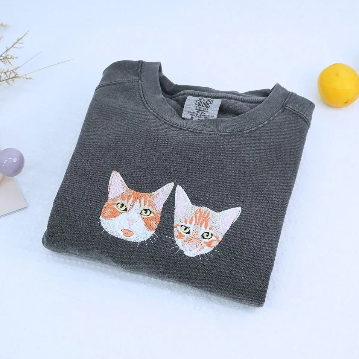 Close-up of custom embroidered dog cat portrait on a Comfort Colors® sweatshirt based on a customer photo