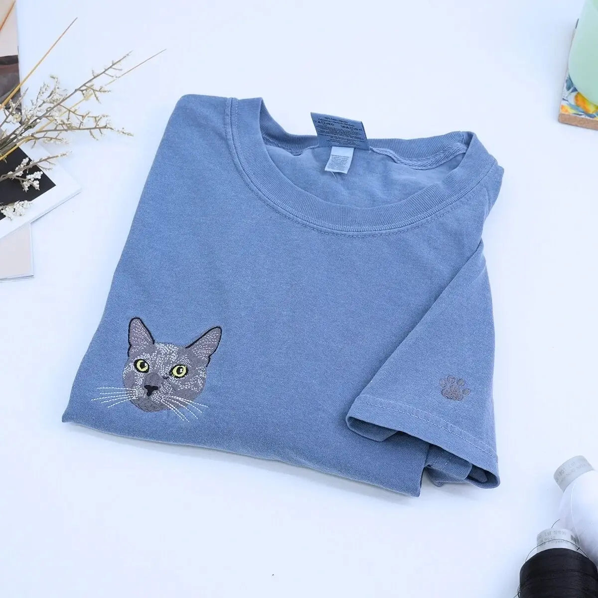Close-up of custom embroidered cat portrait on a Comfort Colors® sweatshirt based on a customer photo