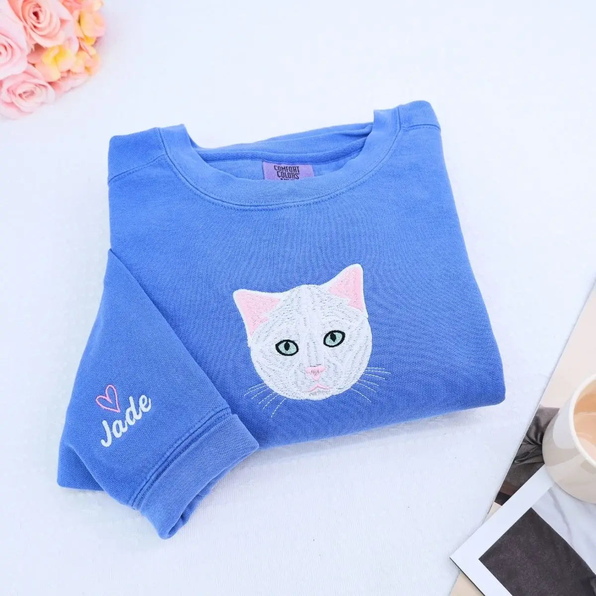 Close-up of custom embroidered dog cat portrait on a Comfort Colors® sweatshirt based on a customer photo