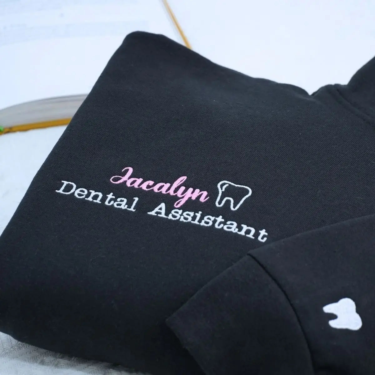 Custom embroidered quarter zip sweatshirt for dental assistant with name or icon on sleeve