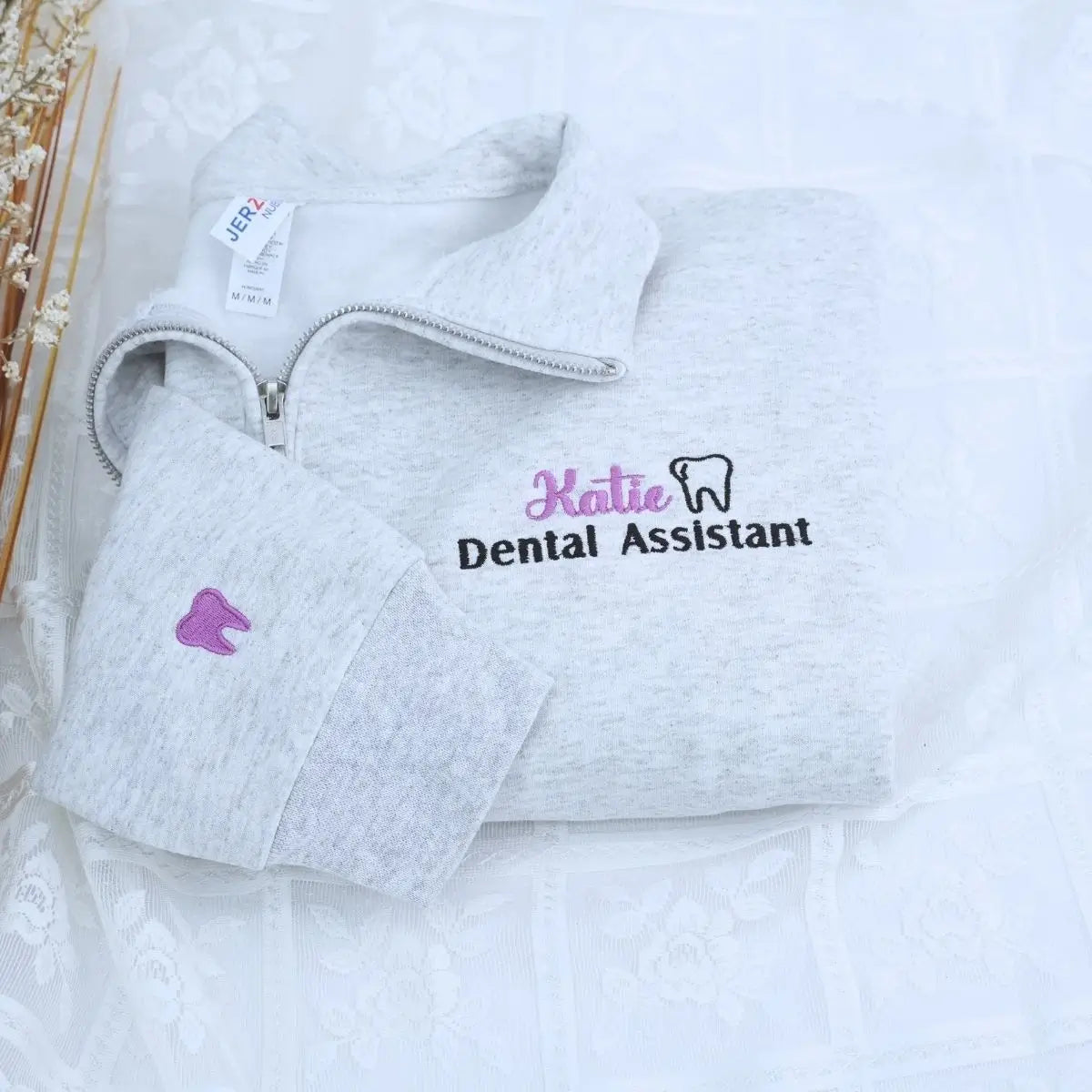 Custom embroidered quarter zip sweatshirt for dental assistant with name or icon on sleeve