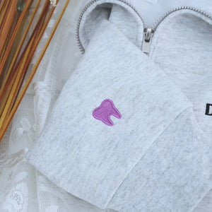 Custom embroidered quarter zip sweatshirt for dental assistant with name or icon on sleeve