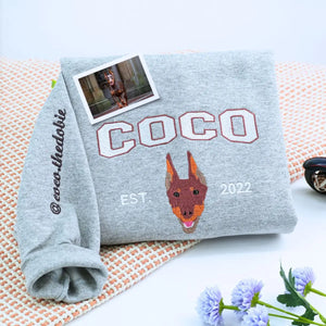 Custom embroidered sweatshirt featuring a realistic portrait of a Doberman dog with name on the sleeve
